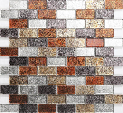 A mosaic tile wall featuring an array of autumn-colored tiles including gold, red, grey, and silver shades, arranged in a brick pattern.
