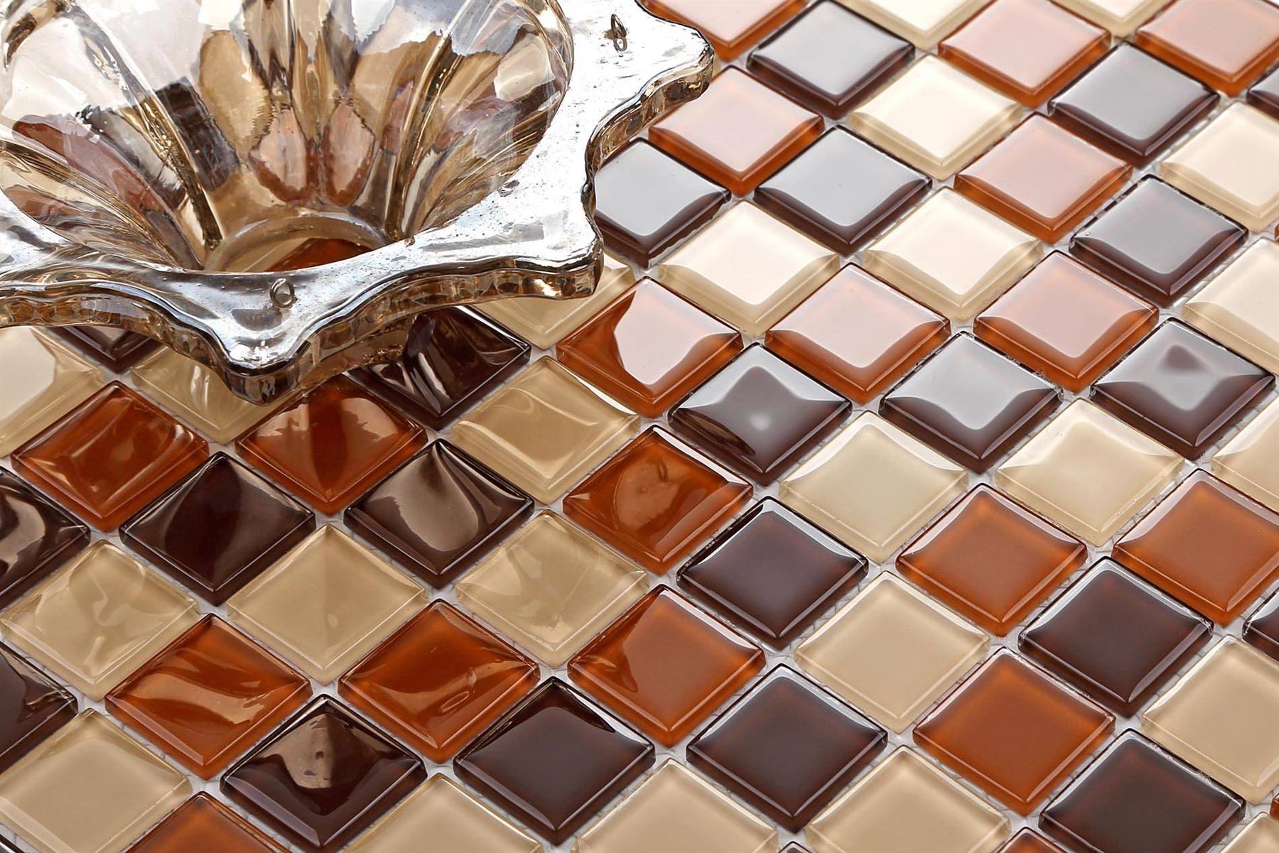Close-up of a glass mosaic tile with brown and beige colors.
