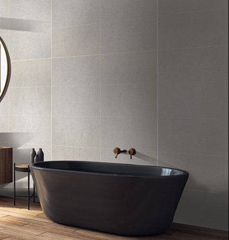 Modern bathroom with a freestanding bathtub, sink, and mirror.