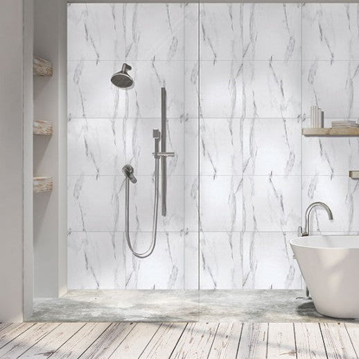 Modern bathroom with freestanding bathtub, shower system, and shelves against a marble wall.