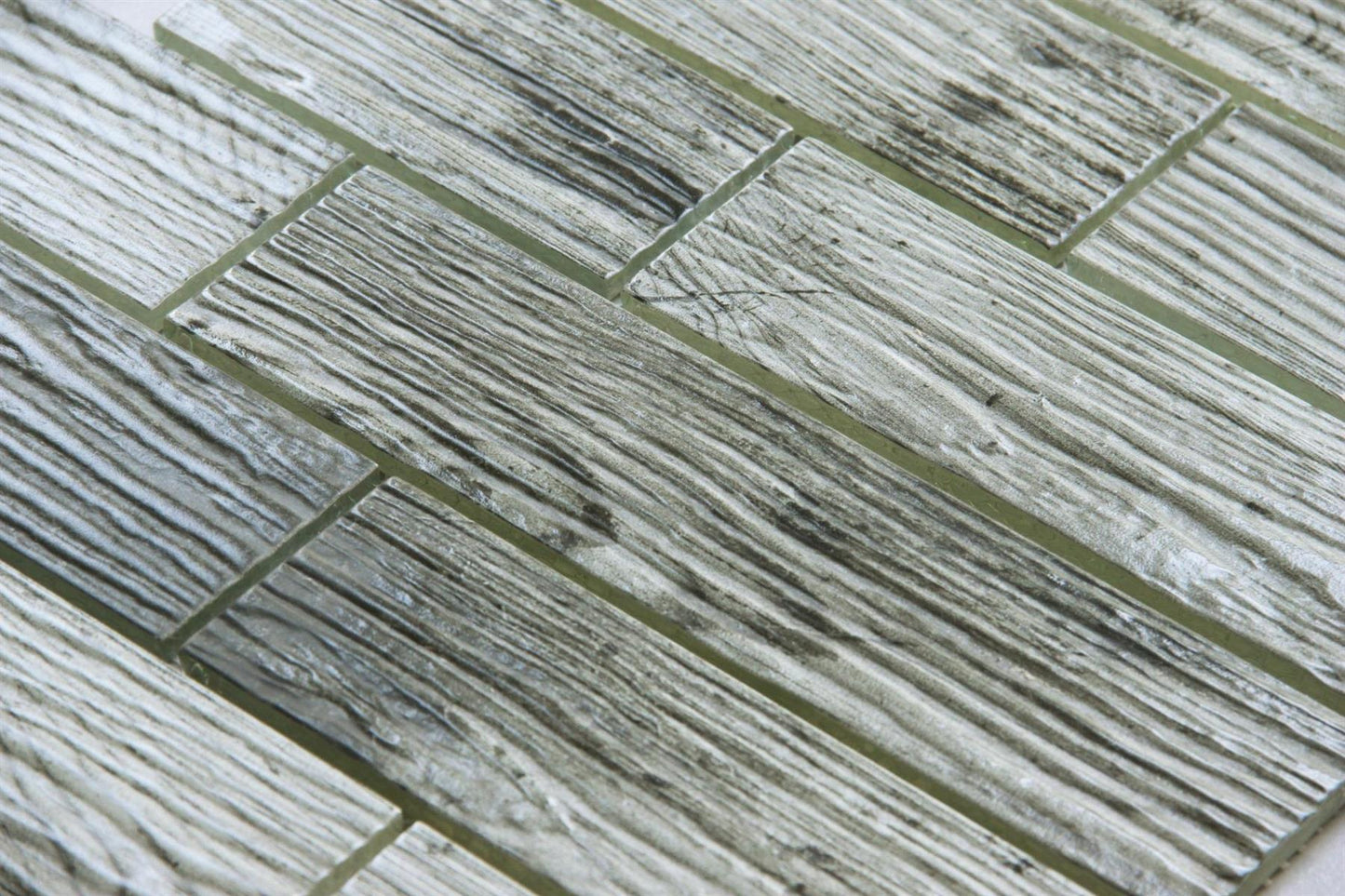 Close-up of gray and white tiles with a herringbone pattern