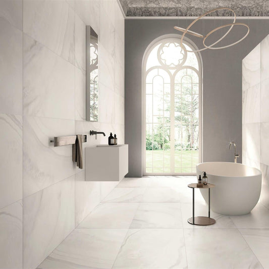 A bathroom setting showcasing a white onyx porcelain tile with a marble-like pattern, used on both the floor and walls.